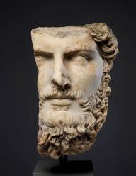 A marble bust of a man with a beard