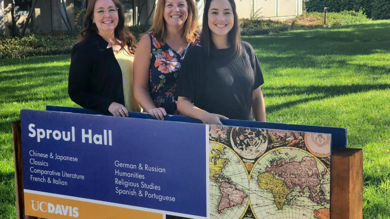 Your advising team standing behind a sign for sproul hall