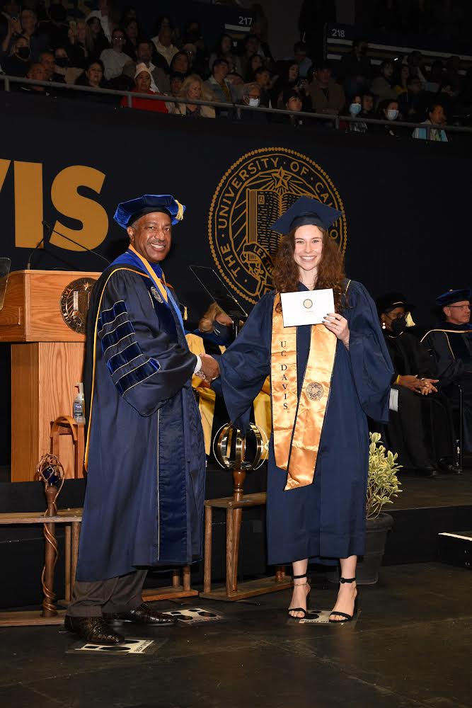 Rachel Roddy shakes Chancellor May's hand at graduation