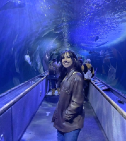 Woman standing in aquarium tunnel