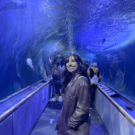 Woman standing in aquarium tunnel