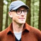 Man wearing baseball cap in the woods